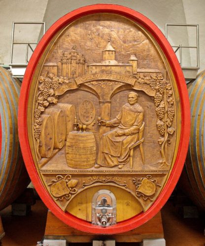 Botte decorativa in legno intarsiato dedicata a Padre Gregor Fellmann, con rilievi raffiguranti scene monastiche e vinicole dell'Abbazia Muri Gries